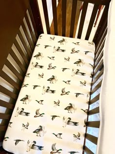 a crib bed with ducks printed on it