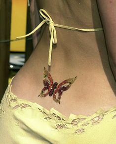 a woman with a butterfly tattoo on her stomach