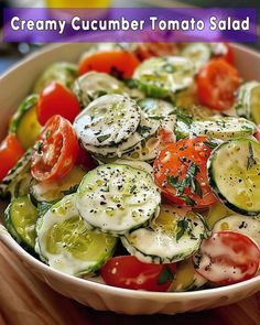 a white bowl filled with cucumber and tomato salad