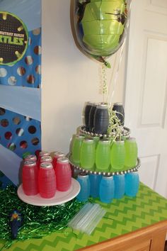 a table topped with drinks and balloons on top of it