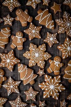 gingerbread cookies decorated with white icing and snowflakes on a wooden table