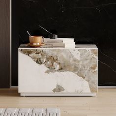 a marble sideboard with books and a cup on it