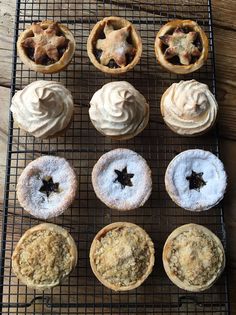 twelve pastries on a cooling rack with icing and star shaped cookies in them