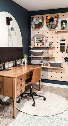 a desk with a computer on top of it in front of a wall filled with shelves