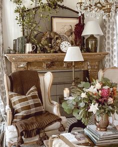 a living room filled with furniture and a fire place next to a mantle covered in flowers