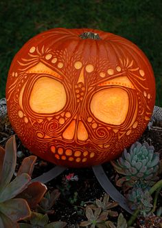 a carved pumpkin with an intricate design on it