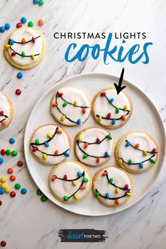 cookies decorated with white frosting and colorful candies are on a plate next to the words tryt