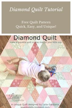 a baby laying on top of a wooden floor next to a pink and white quilt