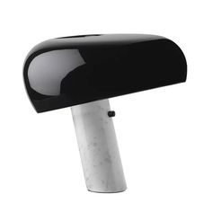 a black and white desk lamp on top of a table