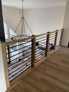 an empty room with wood floors and metal railings