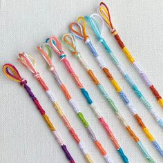 several different colored kitchen utensils lined up in a row