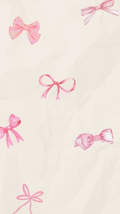 pink bows on white paper with red and blue ribbon around the bow are flying in the air