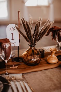 the table is set with candles and place cards