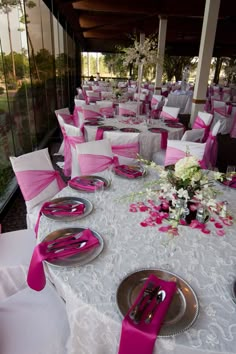 the tables are set with pink and white linens