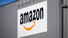 an amazon sign is shown on the side of a building in front of a blue sky