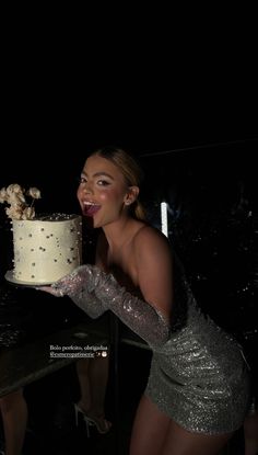 a woman holding a cake in front of her face