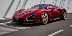 a red sports car driving on a bridge