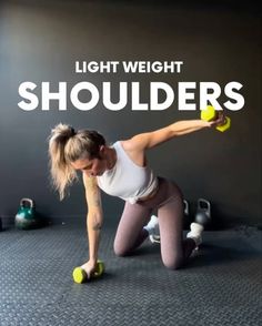 a woman doing push ups with dumbbells in front of a wall and the words light weight shoulders above her