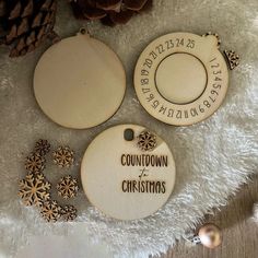 three wooden christmas ornaments on a white rug