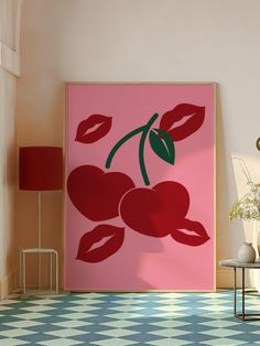 a pink painting with cherries on it in a room next to a table and lamp