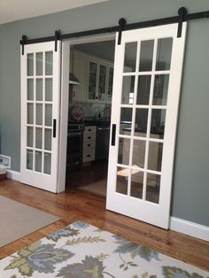 a living room with sliding glass doors and hardwood floors