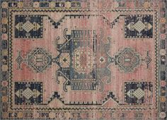 an old rug with many different colors and patterns on the carpet, including blue, pink,