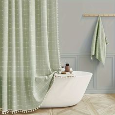 a bath tub sitting next to a shower curtain