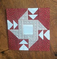 the block is made up of red and white fabric with an arrow design on it