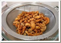 fried food in a strainer on top of a stove burner with the words frugal and traving above it