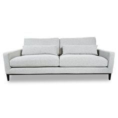 a white couch with two pillows on top of it's back legs and arms