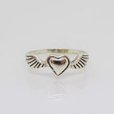 Vintage Sterling Silver Heart & Wings Ring....Marked 925...Total of weights 1.4grams... Size 9...Measure of Face 7MM...It's in very good condition. A Sterling Silver Heart Cut Ring With Heart Charm, Sterling Silver Heart Ring Stamped 925, Stamped 925 White Gold Heart Ring, Valentine's Day Sterling Silver Heart Ring Stamped 925, Sterling Silver Heart-shaped Engraved Ring For Valentine's Day, Heart-shaped Sterling Silver Engraved Ring For Valentine's Day, Valentine's Day Silver Heart-shaped Engraved Ring, Valentine's Day Heart-shaped Sterling Silver Engraved Ring, Cool Silver Rings