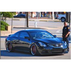 a police officer standing next to a black car