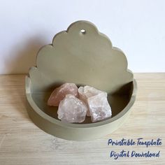 some pink rocks in a bowl on a table