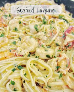 pasta with chicken, shrimp and parsley in a white sauce