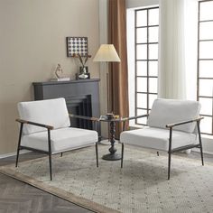 two white chairs sitting on top of a rug