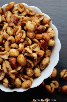 a white bowl filled with nuts on top of a table