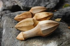 four wooden spoons sitting on top of a rock