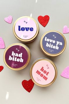 four small tins with different types of love on them sitting next to each other