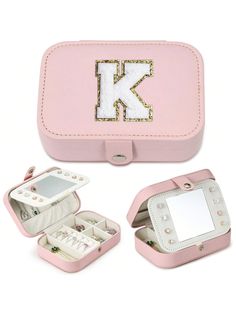 a pink case with the letter k on it and two compartments for jewelry in it