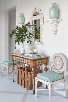 a table with two stools and a plant on top of it in front of a mirror