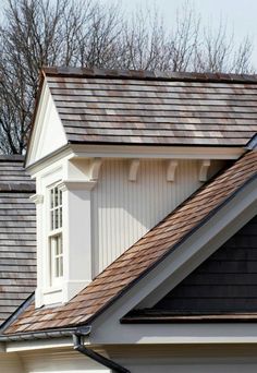 the roof of a house with shingles and windows