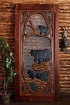 the bear and cub are depicted in this carved wood wall panel, along with other bears