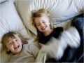 two young children laying on top of pillows