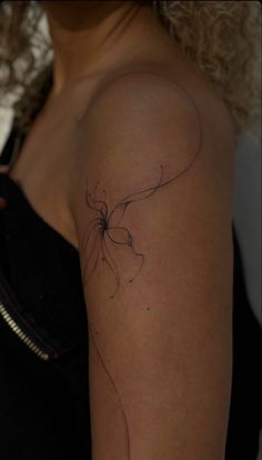 a woman's arm with a tattoo on it that has a flower in the middle