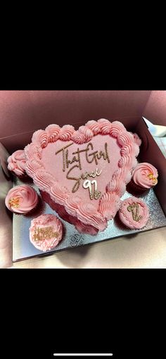 a pink heart shaped cake in a box