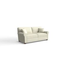 a white couch sitting on top of a white floor