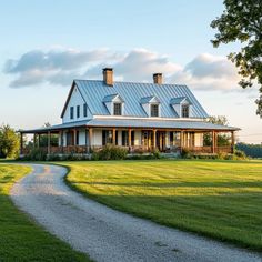 a white house with a blue roof and two chimneys on the top of it's roof