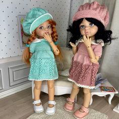 two dolls are standing next to each other