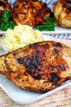 grilled chicken and mashed potatoes on a plate with parsley in the background