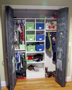 an open closet with chalkboard on the door